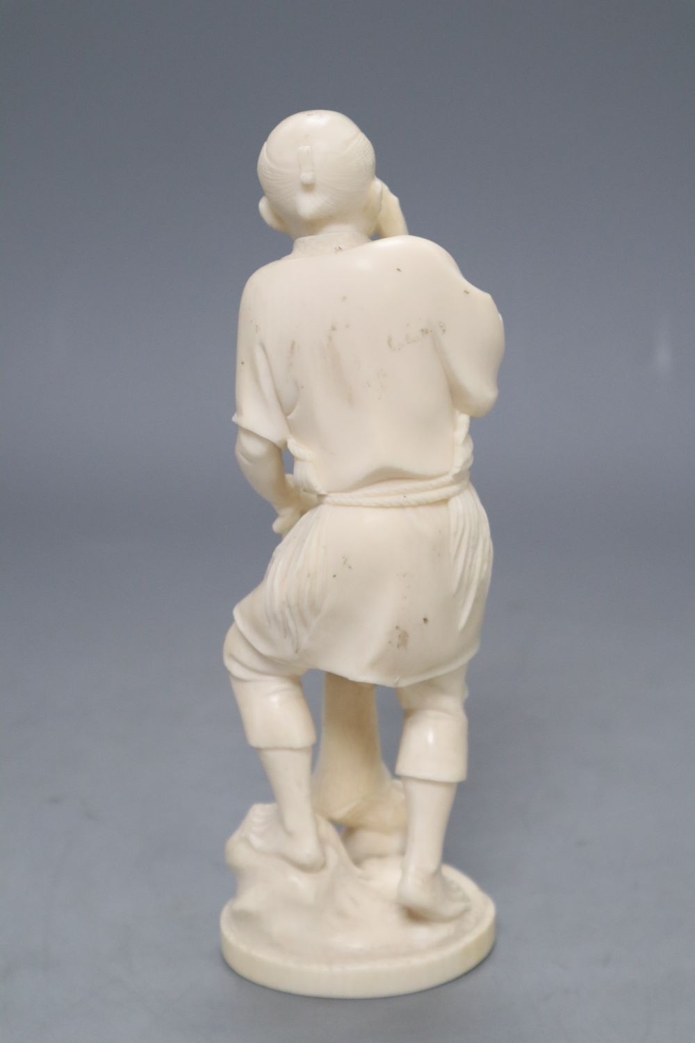 A Japanese Tokyo School carved ivory figure of a fisherman, signed, height 19cm